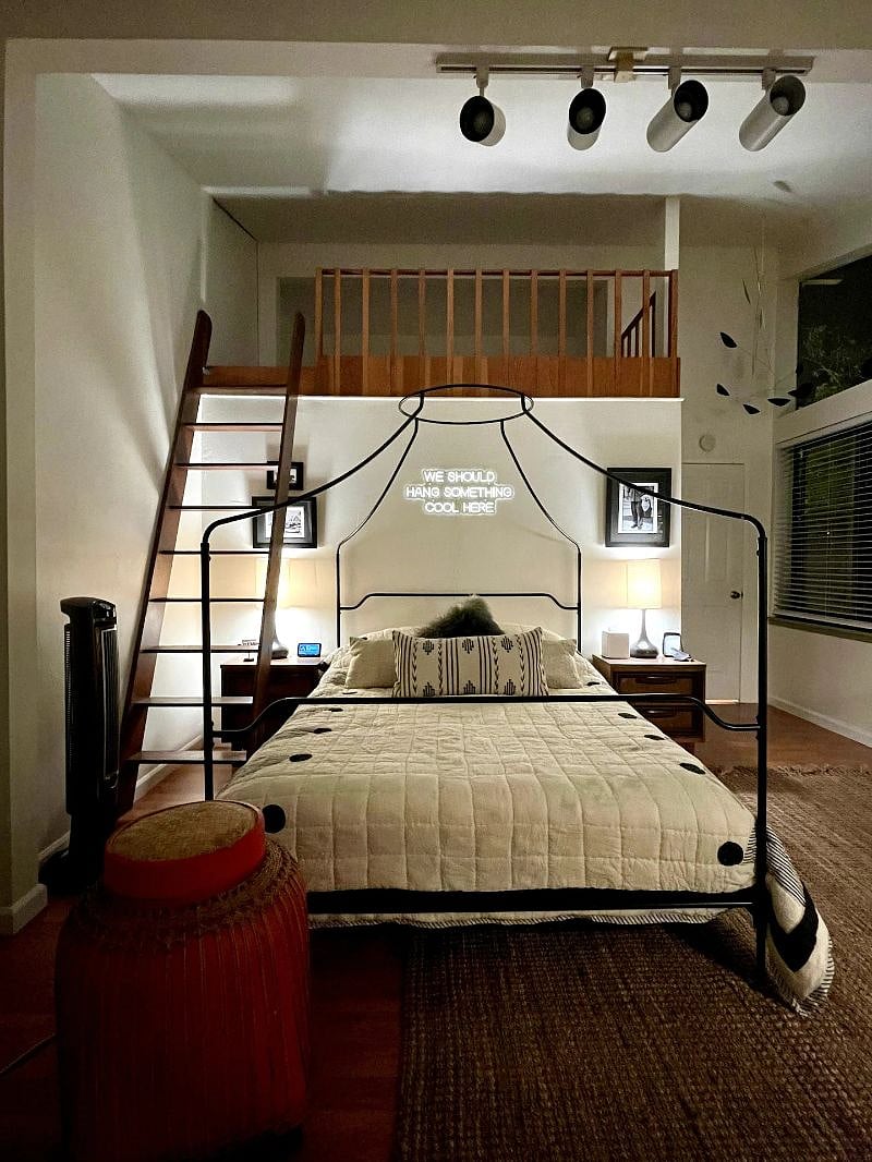 Queen-sized canopy bed, designer bedding, neon art, vintage photography and an extra twin bed in the loft up the ladder.