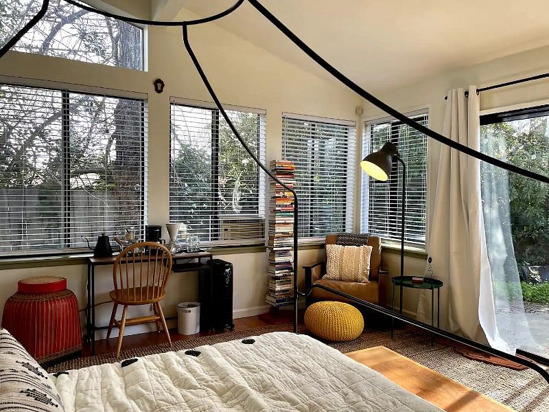 The bedroom's six windows, two skylights and glass patio door lends a cabin-like feeling immersed in nature.
