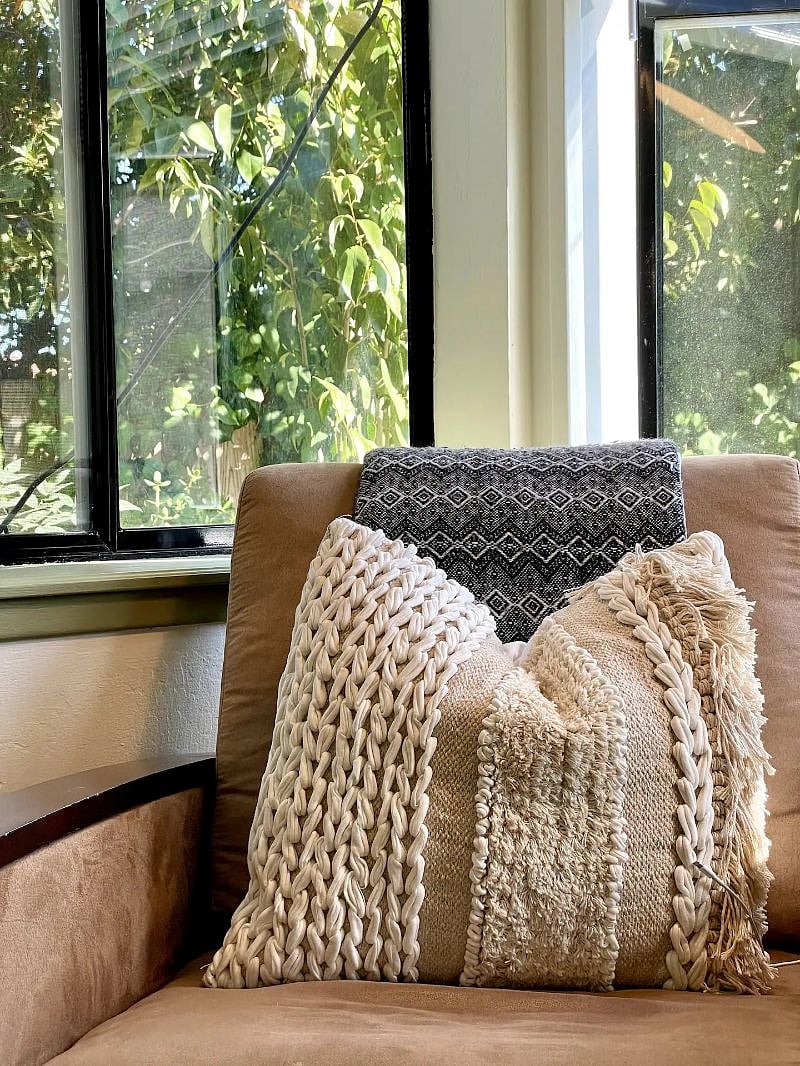 Wool throw and cushion collected on world travels for your reading comfort. We strive to feature natural fibres and one-of-a-kind artisan-made products as much as possible.