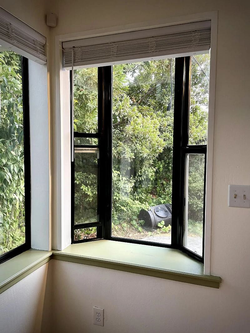 Bay window behind the reading corner lends an extra shelf and receives warmth from all-day sunlight. (And views of the garden!)
