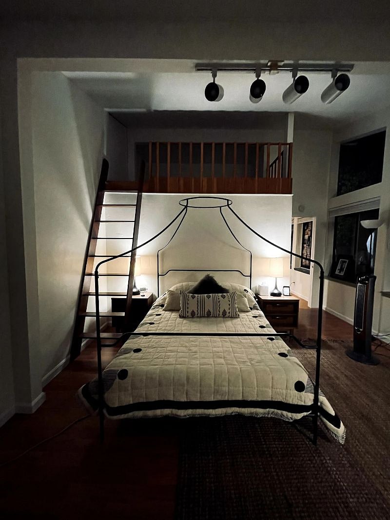 Bedroom by night in soft low lighting.