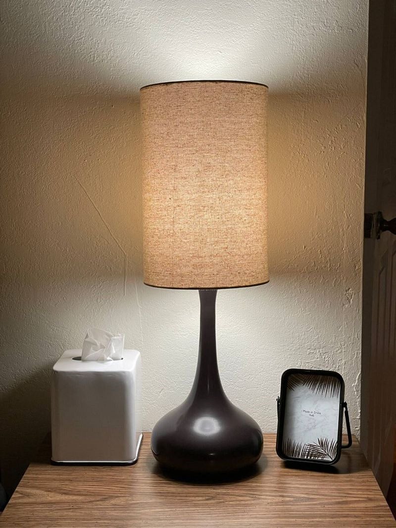 A pair of warm ambient bedside lamp flank your canopy bed.
