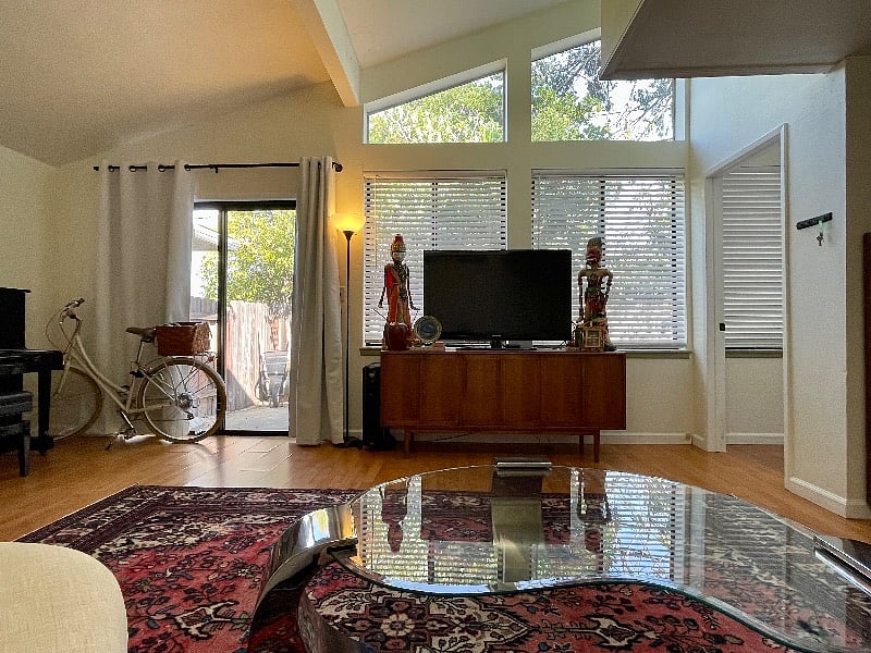 The homes secondary living room, right outside your bedroom, features floor-to-ceiling windows and a sliding door leading into our fairy-lit garden under the big fig tree.