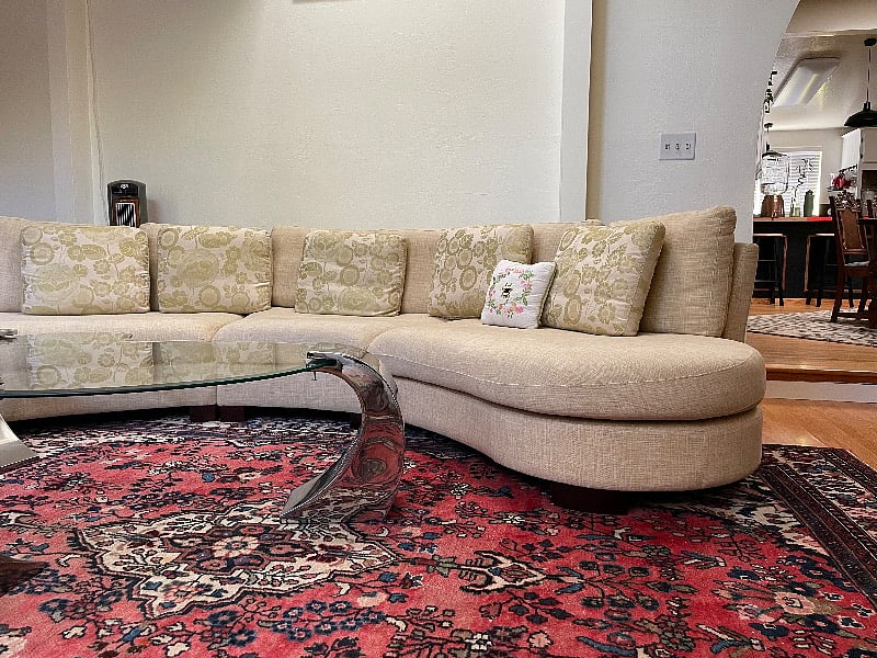 Some of my favourite pieces live in our lounge the sculptural sofa, a treasured Persian rug and the Brutalist coffee table.