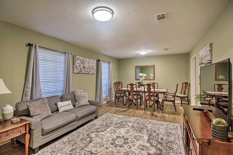 Dining area in a large living room with 55-inch TV