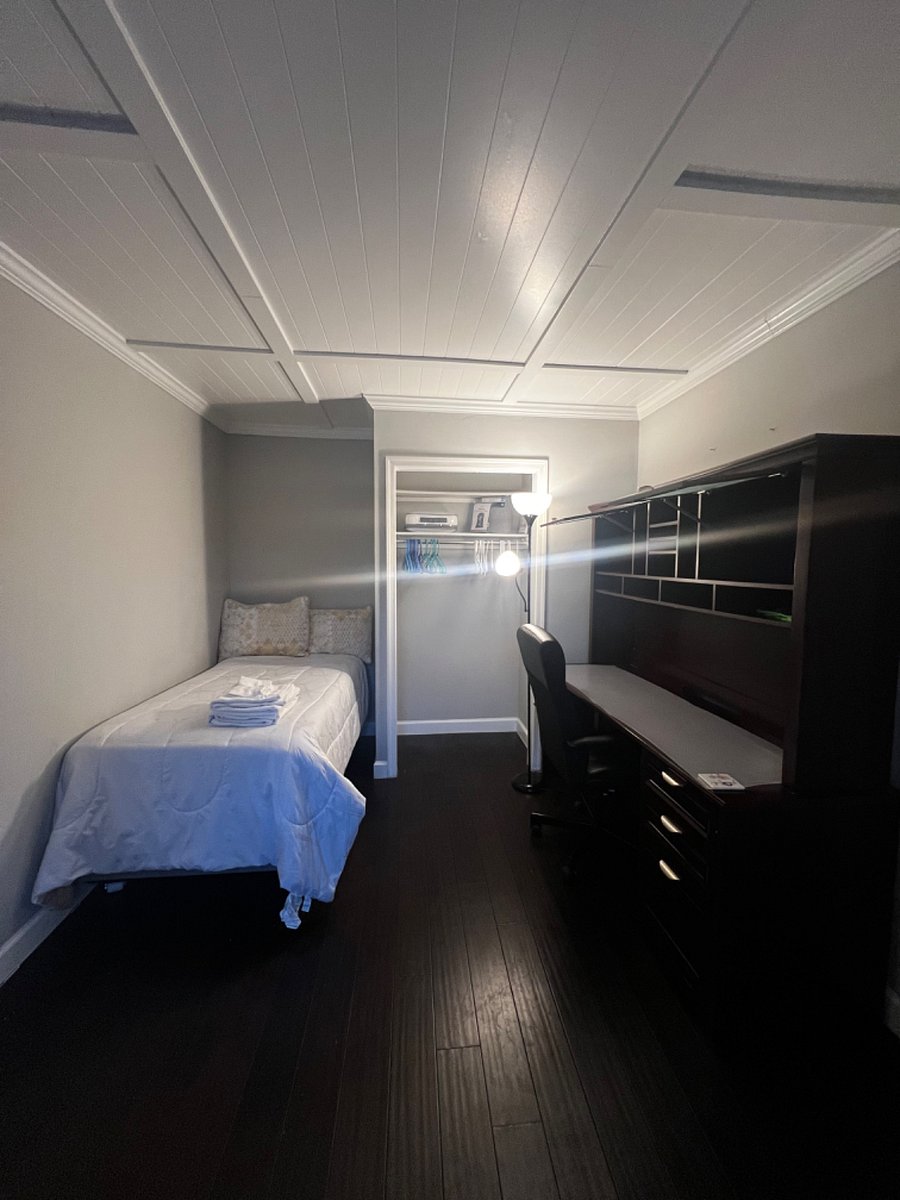 4th bedroom on 1st floor has twin size plush bed, 40" TV, dresser and executive style desk and chair.