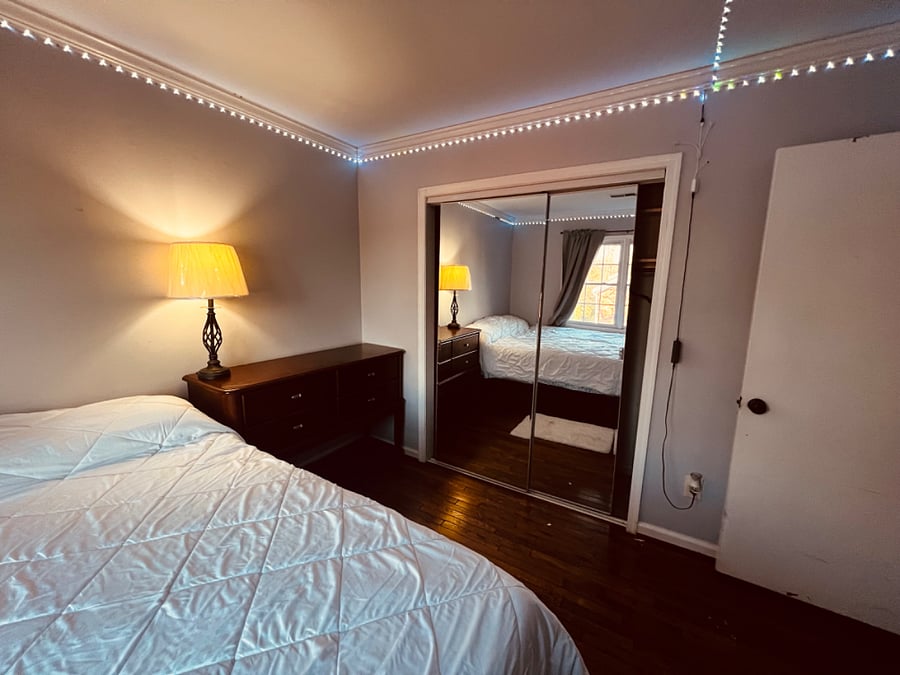 Second bedroom with King sized bed, desk, chair, dresser and large mirrored closet