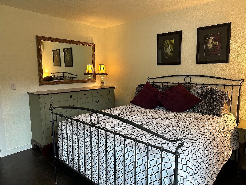 Large dresser in a nice sized bedroom.