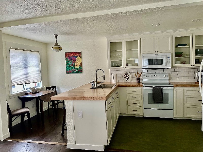 Breakfast bar with 3 stools. Huge kitchen sink.