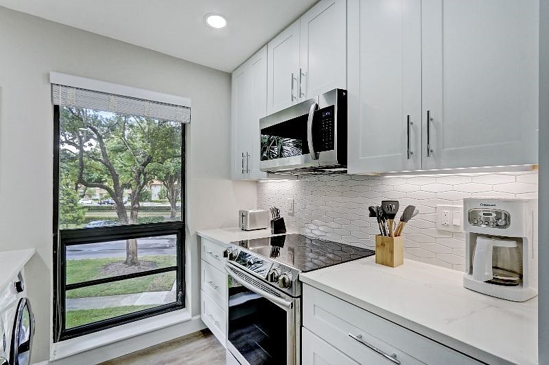 Stove and Microwave with Subway Tile Backsplash and all New Cabinets