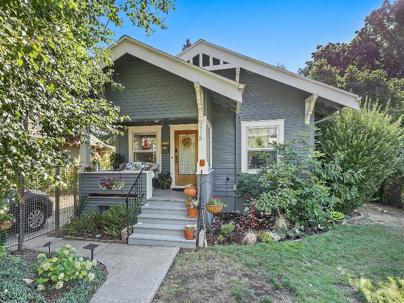 Porch includes padded vintage porch swing for evenings outdoors.
