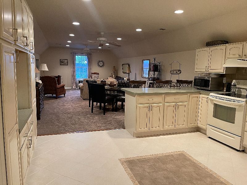 Up the stairs and to the right, is the kitchen, dining room and living room. There is a TV for this room above the fireplace and it will be installed before you arrive!