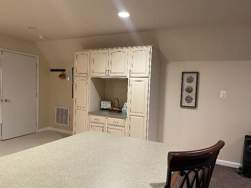 Kitchen is fully stocked with utensils, cookware, dishes and cleaning supplies.
