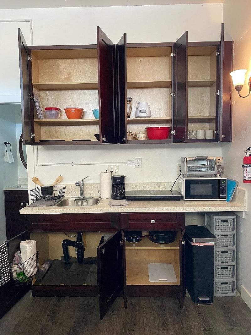 Stocking the kitchen with bowls, a blender, table setting for 4, coffee mugs, Tupperware....