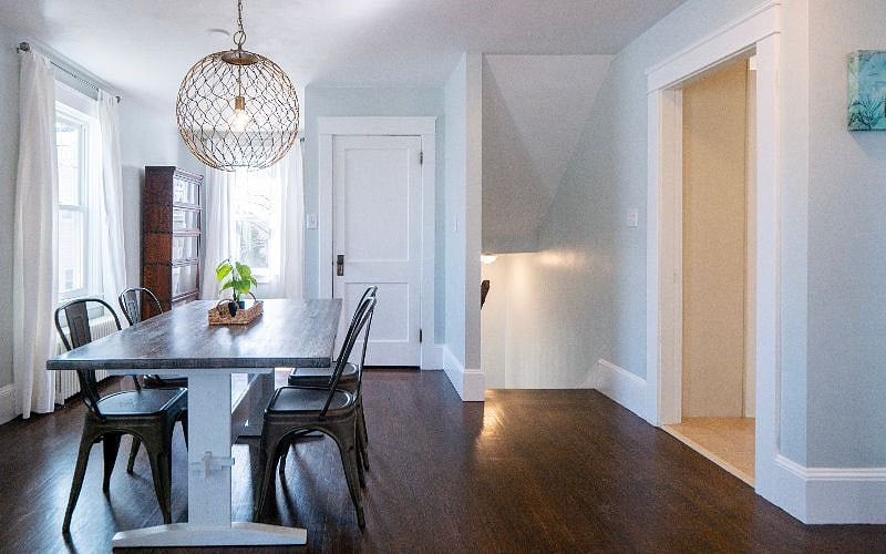 View of staircase leading up to the living room dining room area.