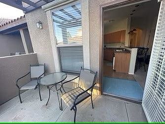 Patio off kitchen with view of pool area