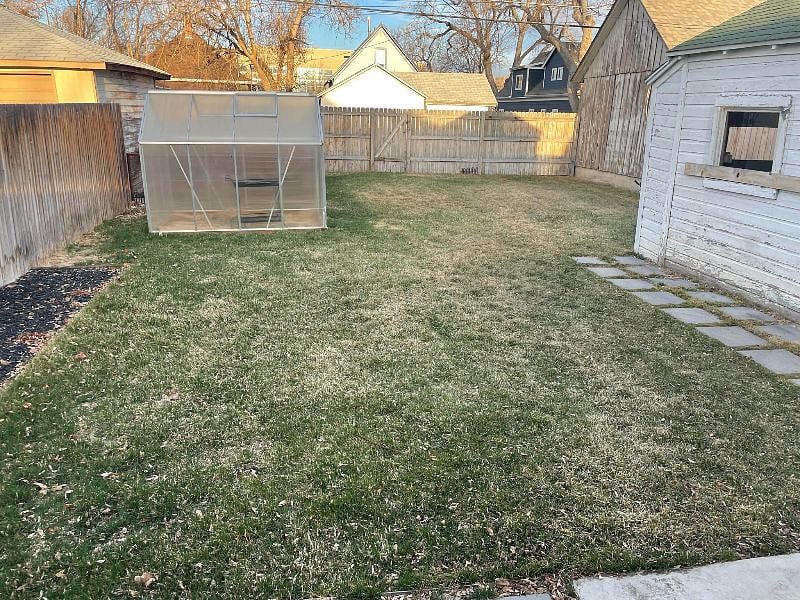 Large backyard with greenhouse