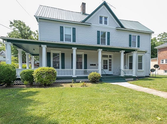 Front of fourplex showing gorgeous wrap around southern porch.