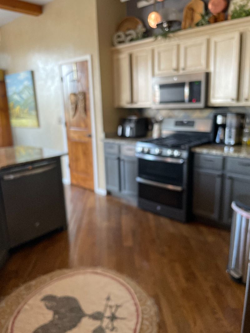 The kitchen has a double oven, an air fryer, and all newer appliances.It shares a sunny common space with a dining table that leads to additional outdoor dining and  seating.