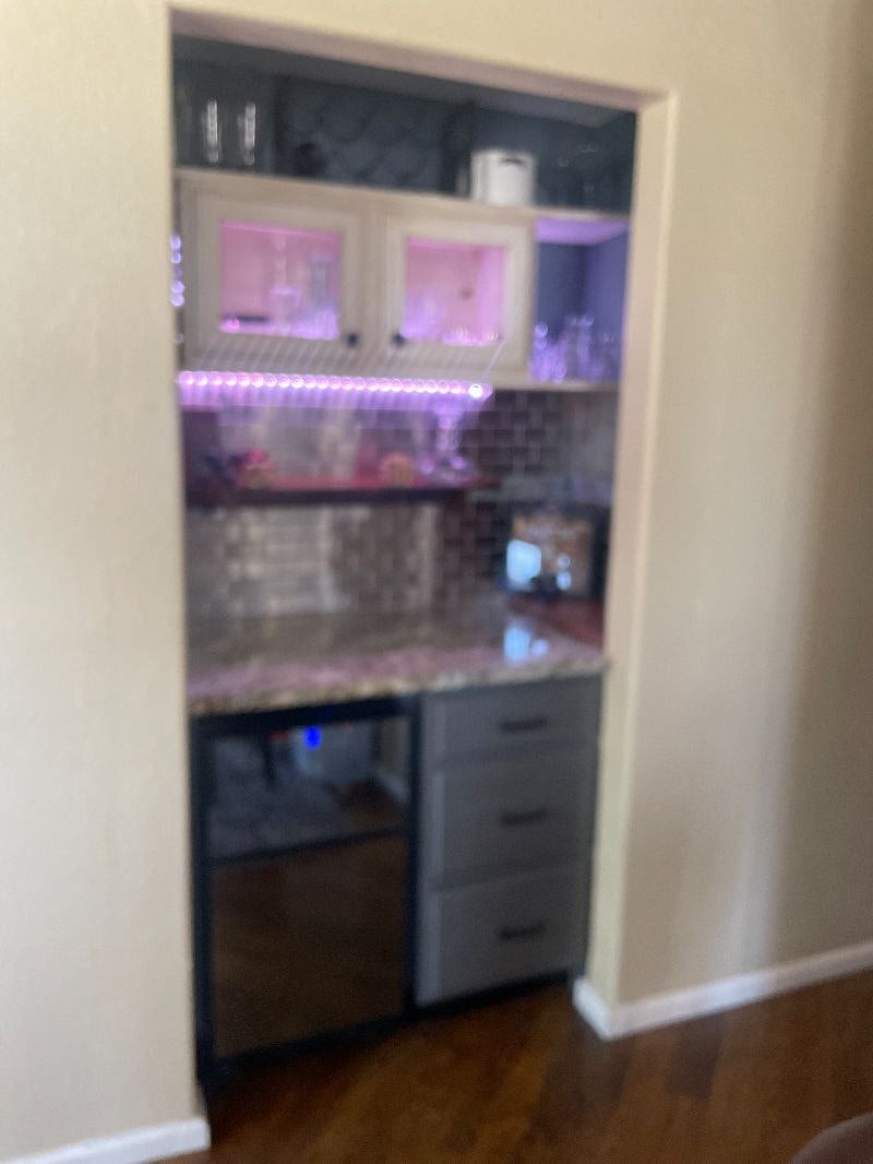 Hallway bar and wine fridge off of the front whiskey lounge.