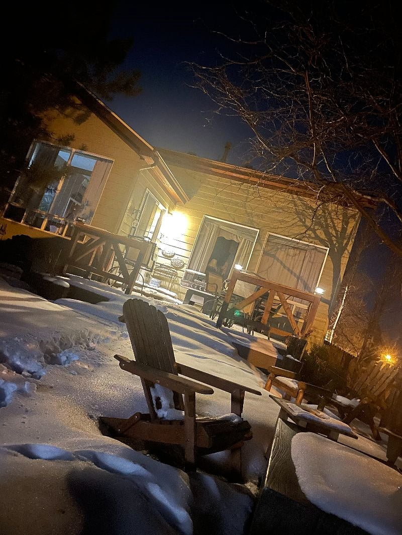 Upper outdoor patio view from the hot tub. This upper level has a propane fire table and is surrounded by adirondack seating.