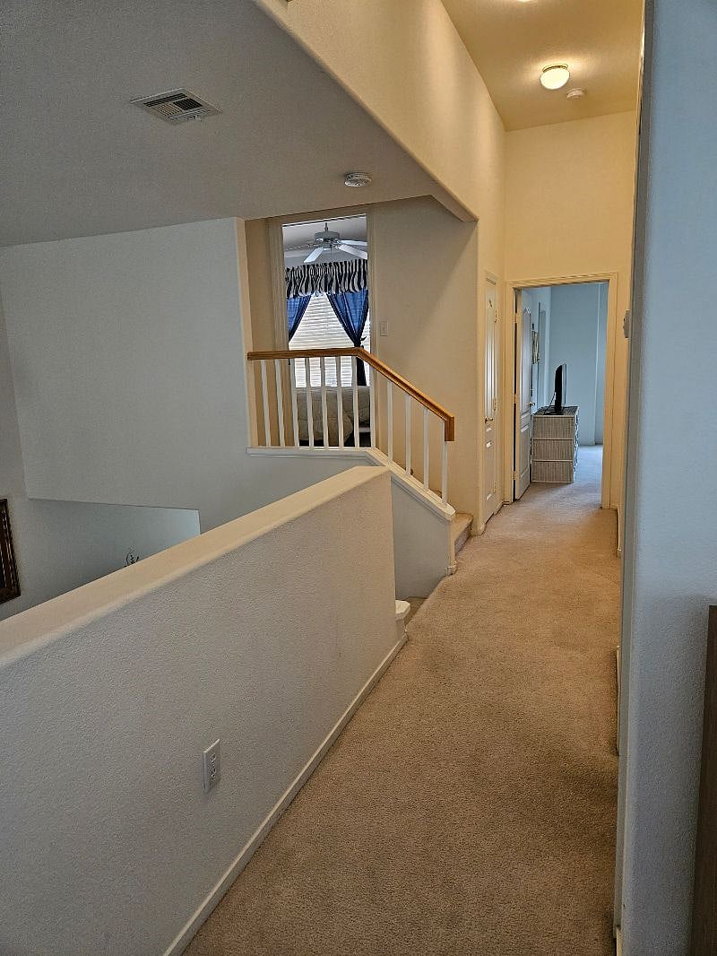 Hallway with washer/dryer, looking into both bedrooms