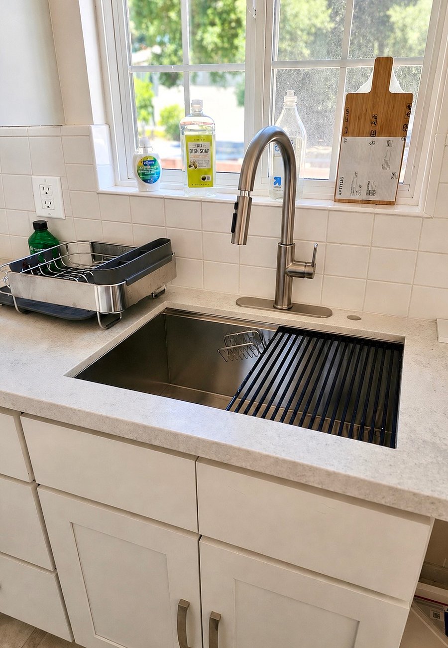 The kitchen countertop and sink are newly remodeled