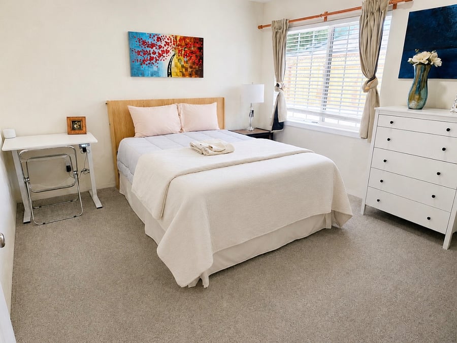 Bedroom 1 with Queen bed, recessed lighting, carpet, ample storage, tons of natural light, sliding wardrobe, mini-split AC, mini standing desk