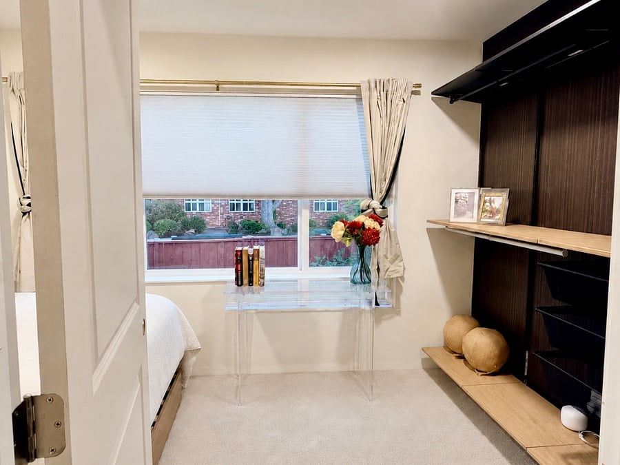 Bedroom 2 with a Full sized bed, carpet, sun-drenched view, modern shelving, desk