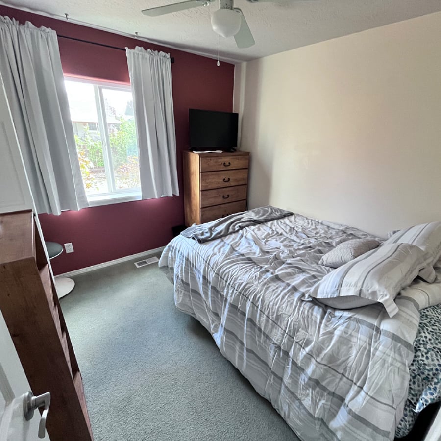 3rd bedroom w/ full bed, ceiling fan, smart TV, and blackout curtains.