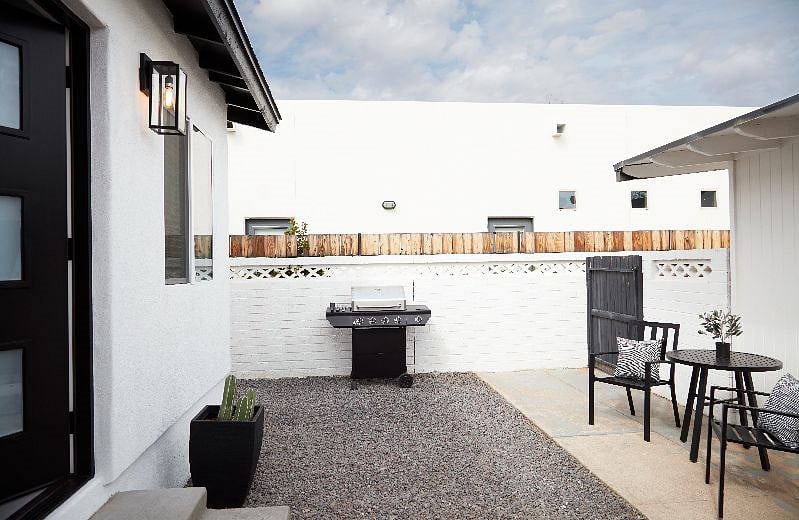 Private patio area with a bbq grill