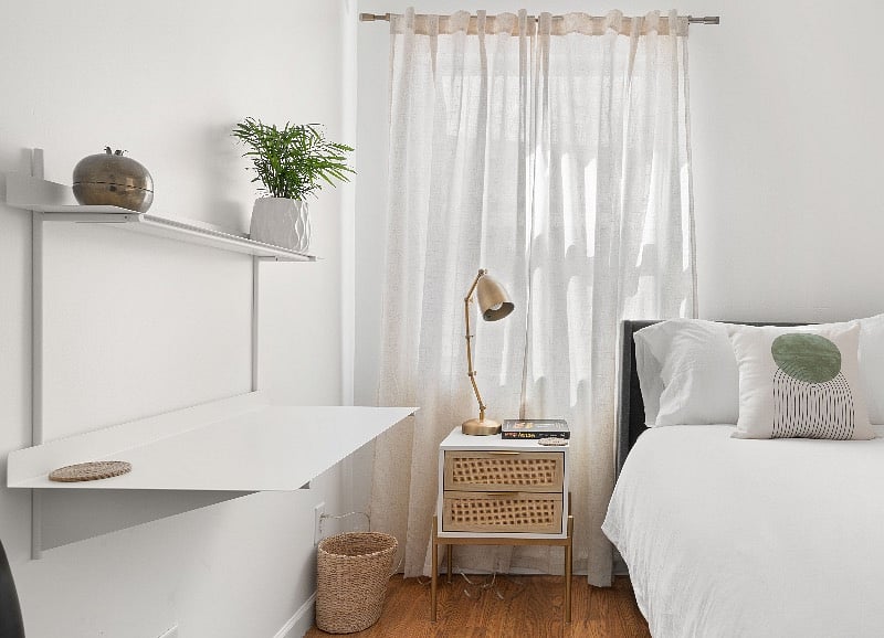 Two nightstands and natural banana leaf waste bin. Crisp white accented by olive green, natural jute, and brass colors.