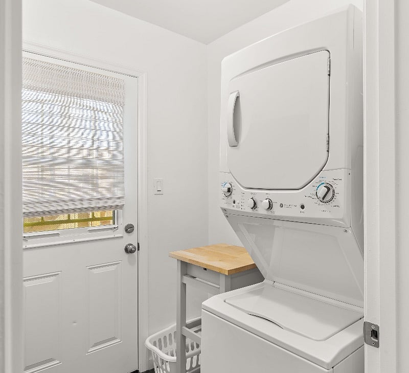 Natural white cordless bamboo shades on the back-door window of the house, located at the laundry room, provide privacy while letting in light. The cart provides a surface for folding clothes or can be wheeled into the adjoining kitchen for additional counter space, if preferred.