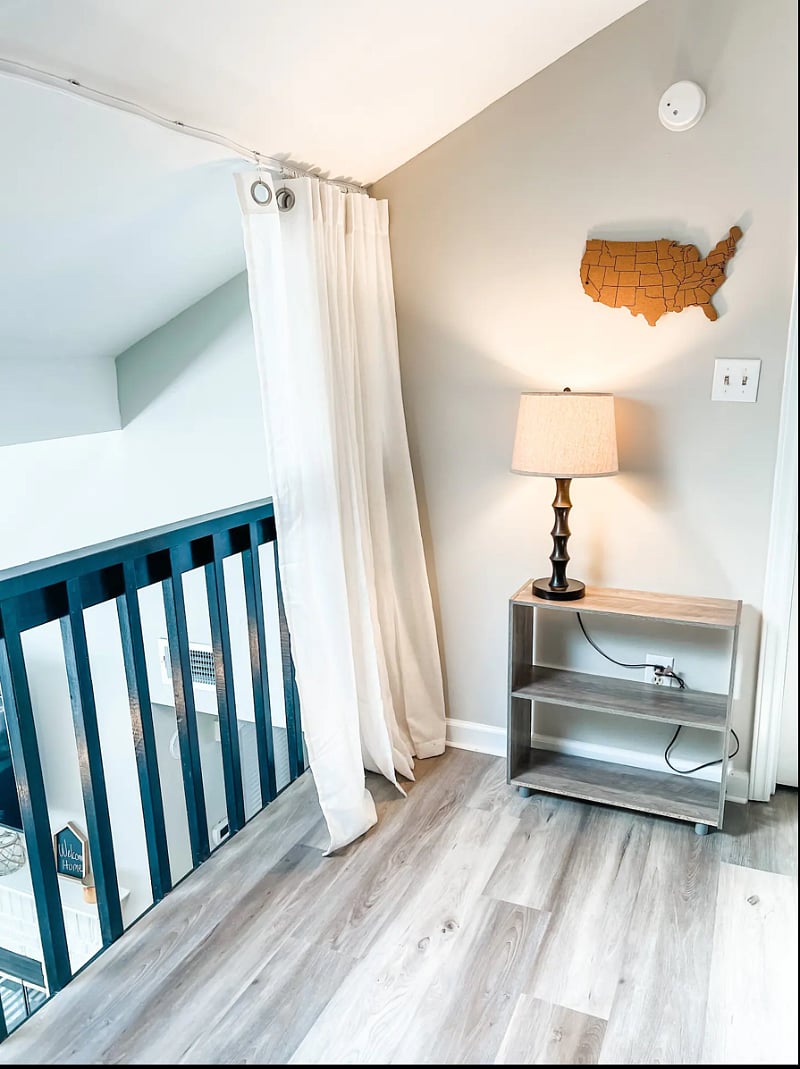 Loft area featuring curtains that can be closed for privacy. Bookcase will also feature games that can be used by guests.
