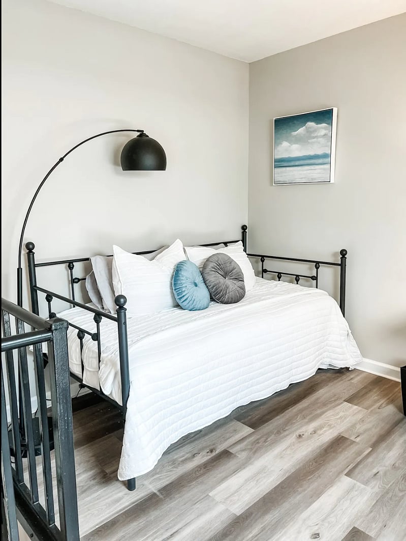 Loft area featuring a twin daybed and overhead light. *Accessible via spiral staircase