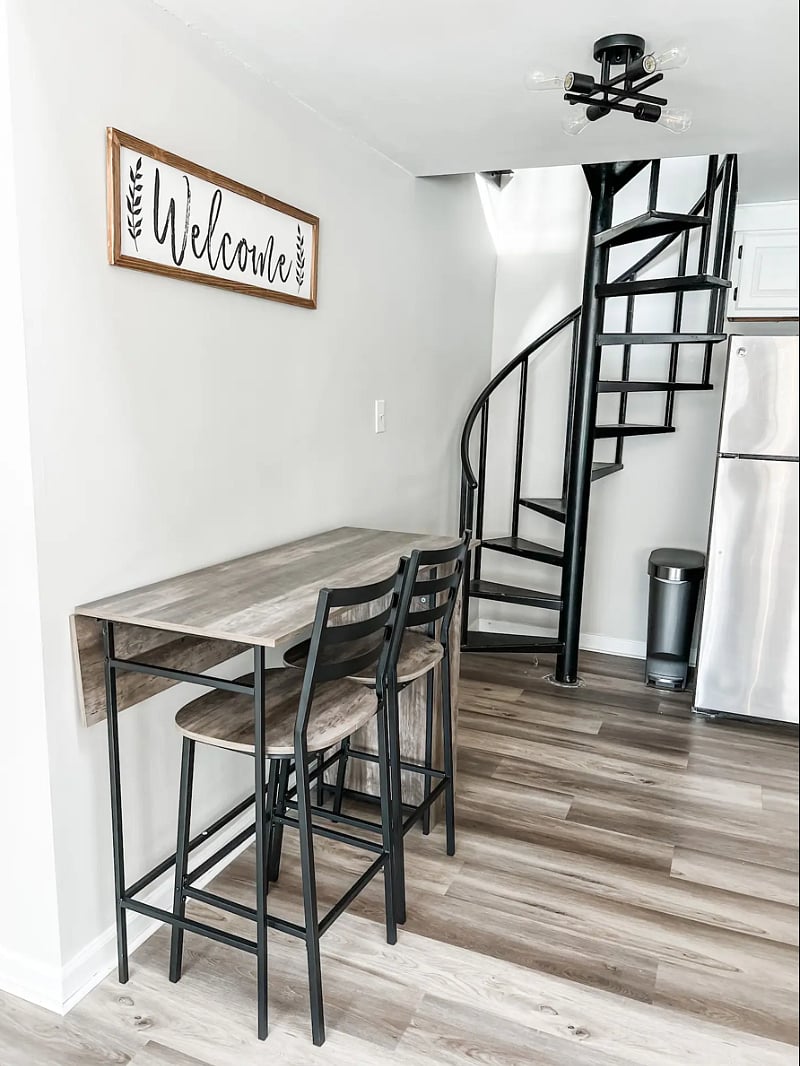 Drop-leaf table that can be pulled out and extended as needed. The spiral staircase leads up to the 2nd floor loft.