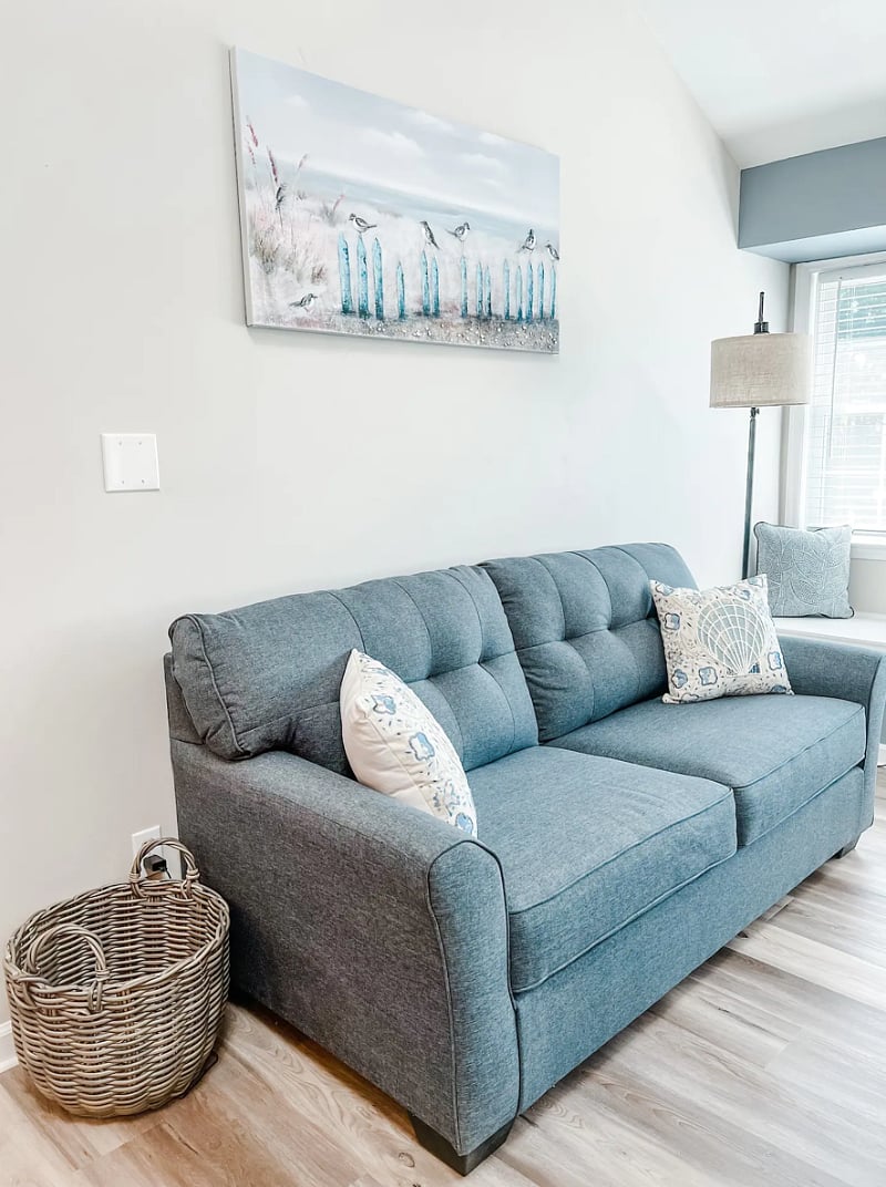Sofa that can be transformed into a full-size bed for guests. *Bedding provided in-unit.