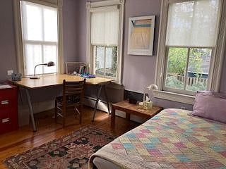 Tenant bedroom with double bed, desk, arm chair