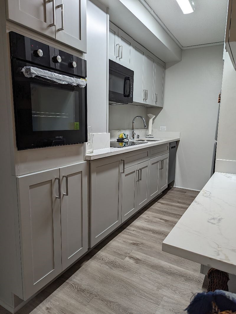 front door is to the left of the oven
