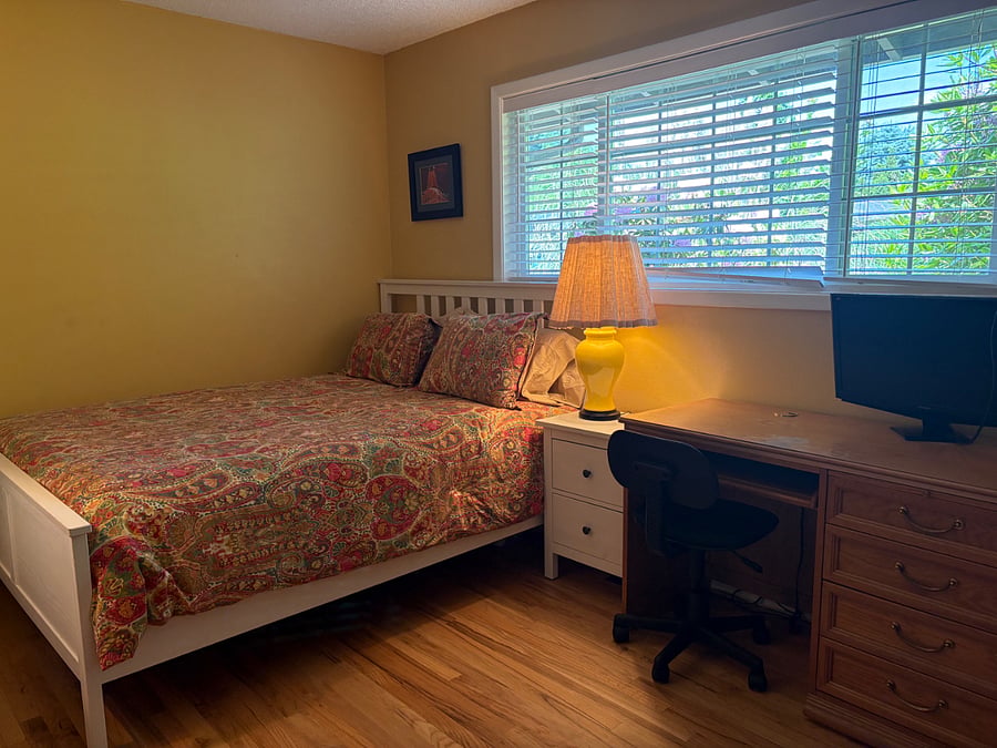 Secondary bedroom with full desk set up for work-from-home scenario.