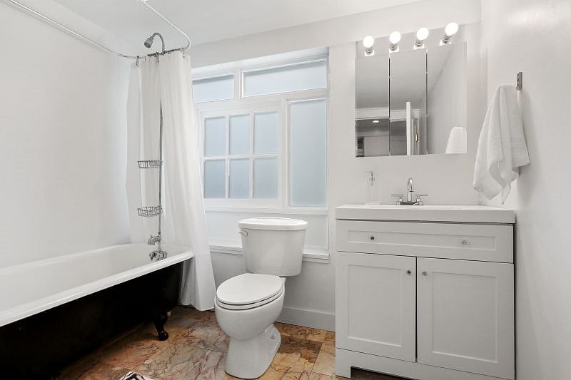 The focal point of the bathroom is a restored antique clawfoot tub with shower.