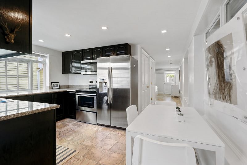 The kitchen is connected by hallway to the bathroom and bedroom at the rear of the apartment.