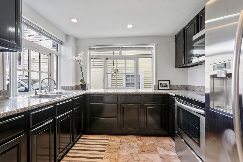 The full kitchen includes electric stove and oven, refrigerator with filtered water and ice, Nespresso and conventional coffee makers, toaster, blender, and kitchen basics. Guests are also invited to take advantage of weekly compost pickup.