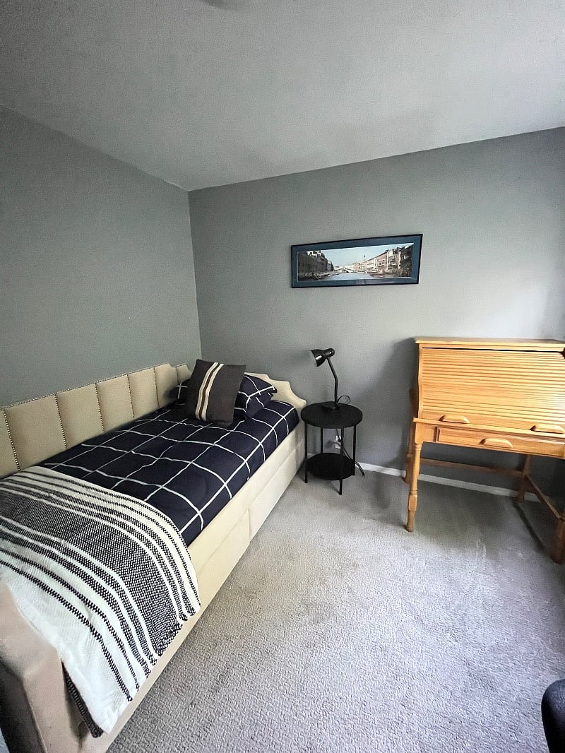 Third bedroom with twin daybed and secretary desk. Small closet