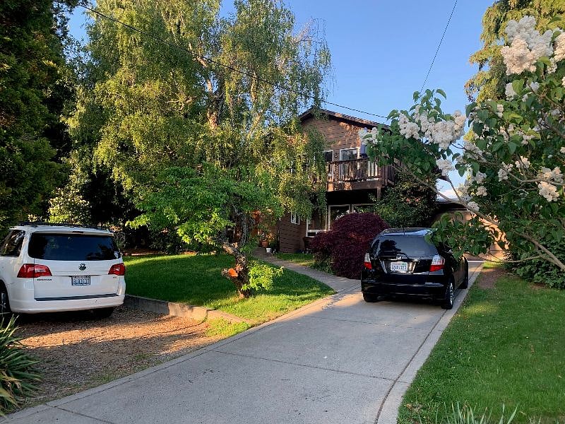 Main house with parking spot (where the white car is parked)