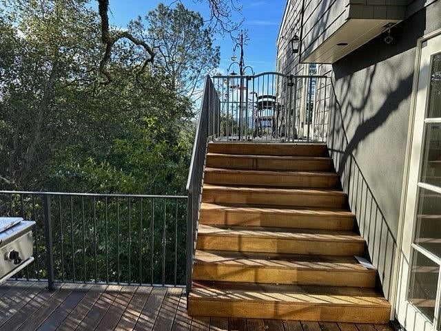 Side deck off kitchen with a Brown Jordan table and two chairs. A great place for morning coffee. Gate shown is no longer present.