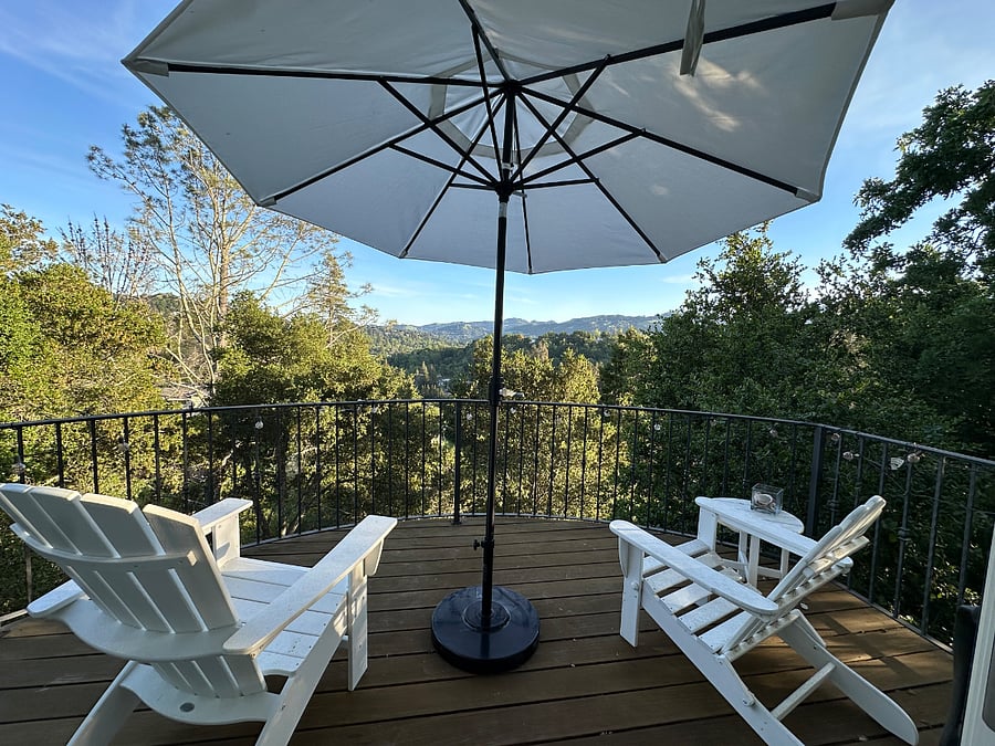 Upstairs deck off of dining area. Enjoy space with umbrella up or down. Sun, sun, sun (unless it's raining:-). )