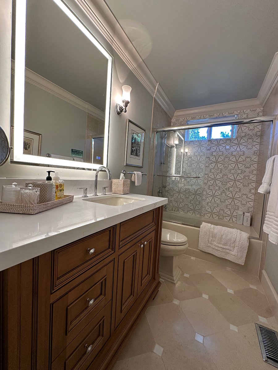 Private bathroom showing natural light, tub and shower combo with detachable shower head.