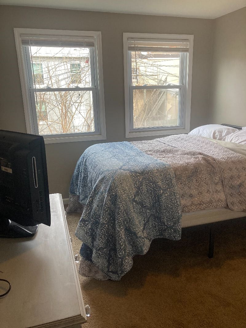 Comfortable bed, TV, both windows have blinds.