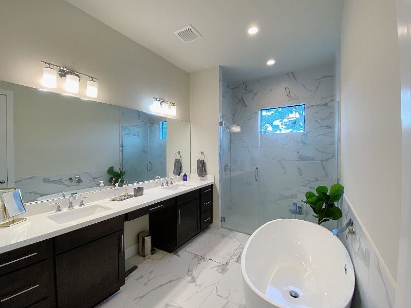 The Primary Suite includes a luxury bathroom double vanity and large tub.
